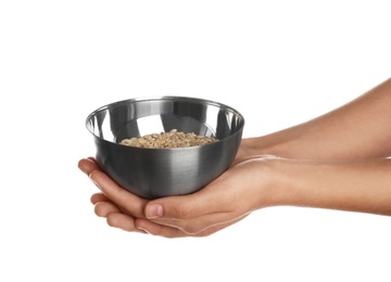 Photo of Poor woman holding bowl with grains on white background, closeup