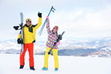 Lovely couple with equipment at ski resort. Winter vacation