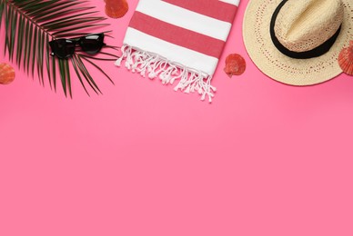 Flat lay composition with different beach objects on pink background, space for text