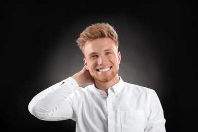 Portrait of handsome young man on dark background