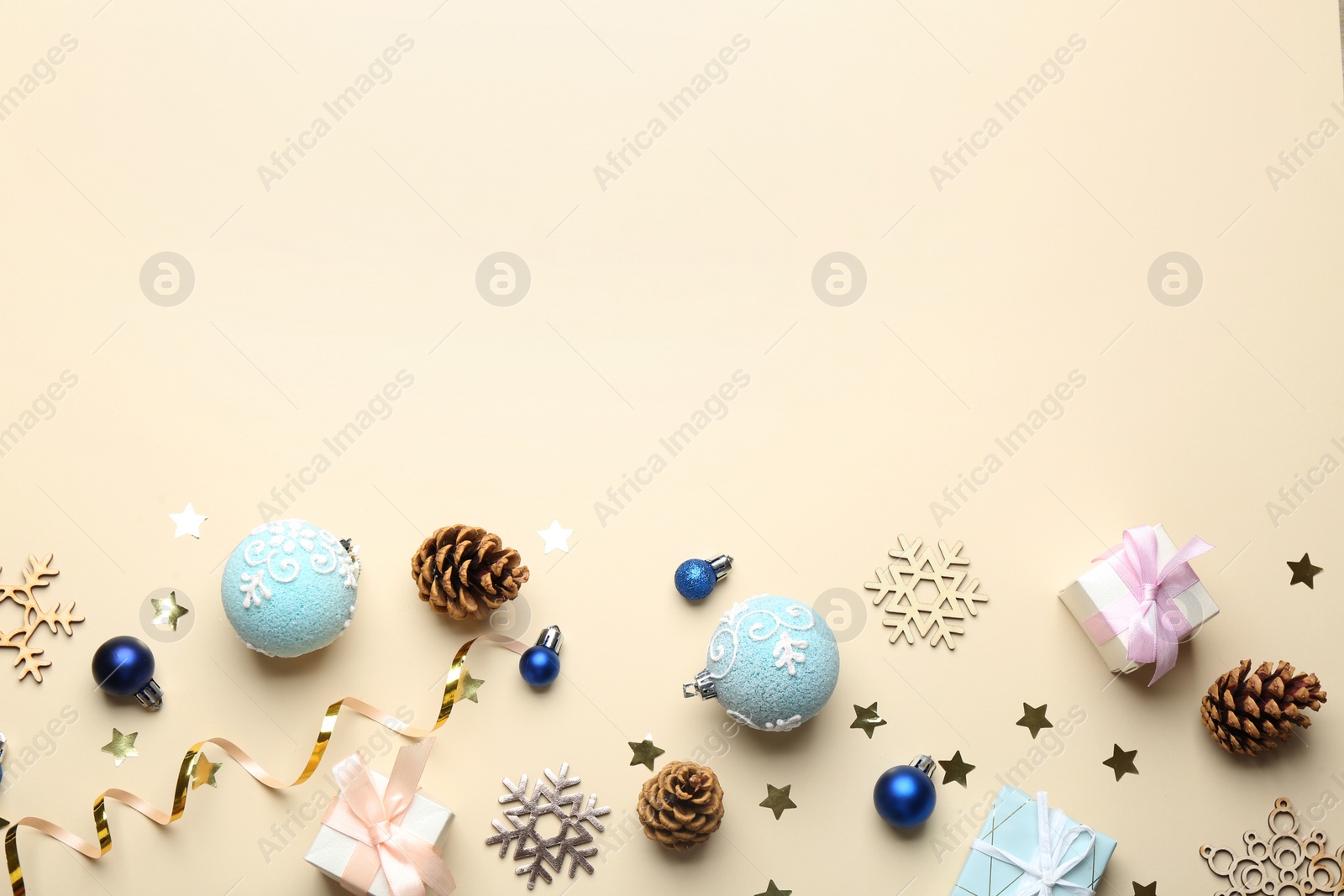 Photo of Flat lay composition with Christmas decorations on beige background, space for text. Winter season