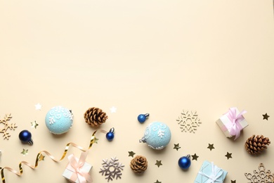 Flat lay composition with Christmas decorations on beige background, space for text. Winter season