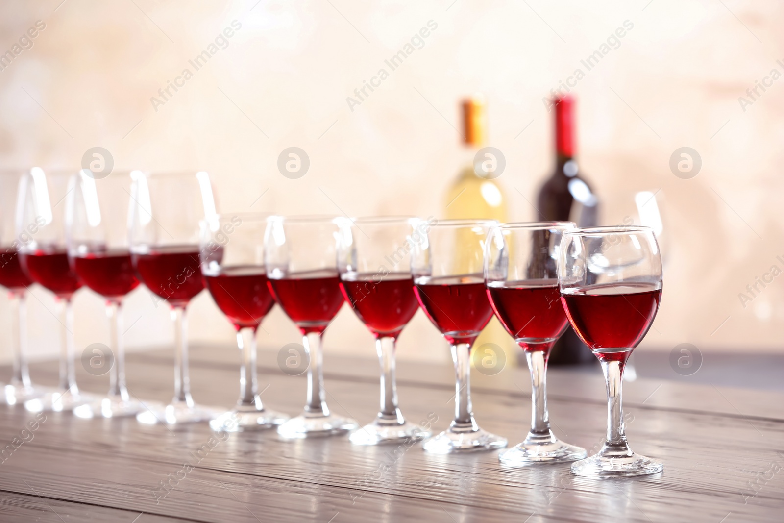 Photo of Glasses with delicious red wine on table