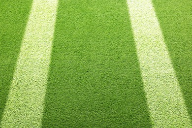 Image of Green grass with white markings, closeup view