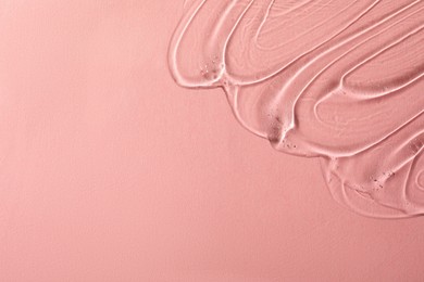 Cosmetic gel on pink background, top view. Space for text