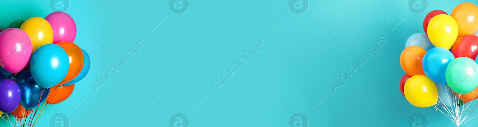 Image of Bunches of bright balloons on light blue background, space for text. Banner design 