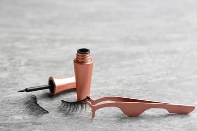 Magnetic eyelashes and accessories on grey table