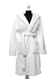 Photo of New comfortable bathrobe on mannequin against white background