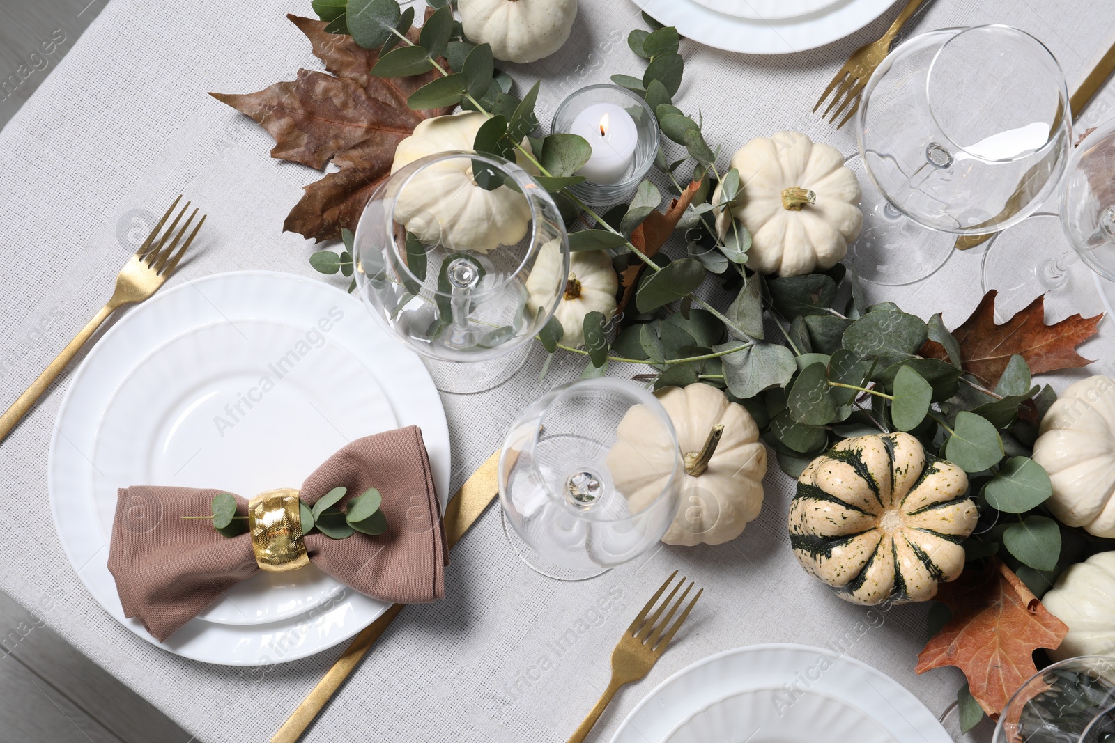 Photo of Beautiful autumn table setting. Plates, cutlery, glasses, pumpkins and floral decor, flat lay