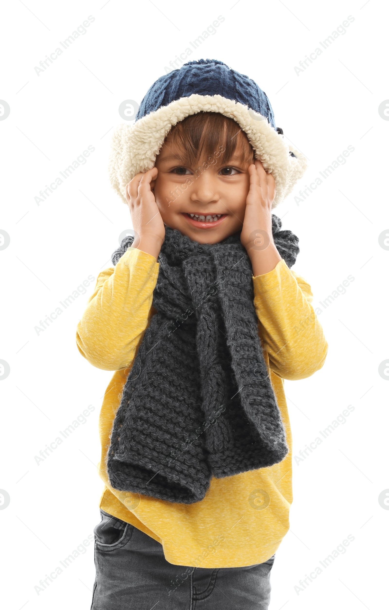 Photo of Cute little boy in warm clothes on white background. Winter vacation