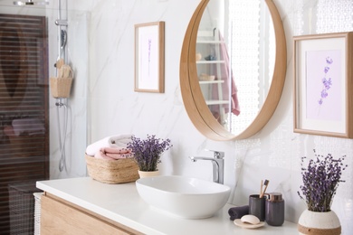 Photo of Mirror and counter with vessel sink in bathroom interior. Idea for design