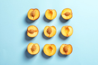 Flat lay composition with ripe peaches on color background