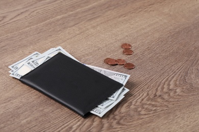 Pension certificate with American money on brown wooden background. Space for text