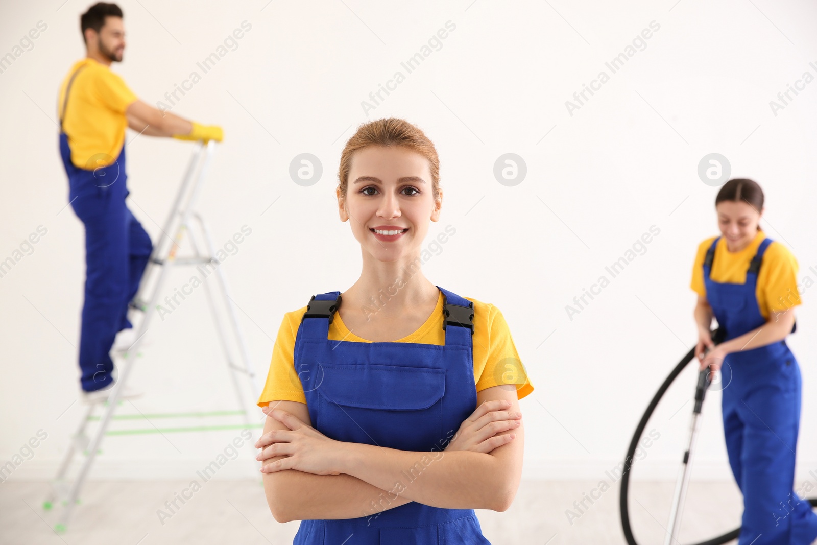 Photo of Professional janitor in uniform indoors. Cleaning service