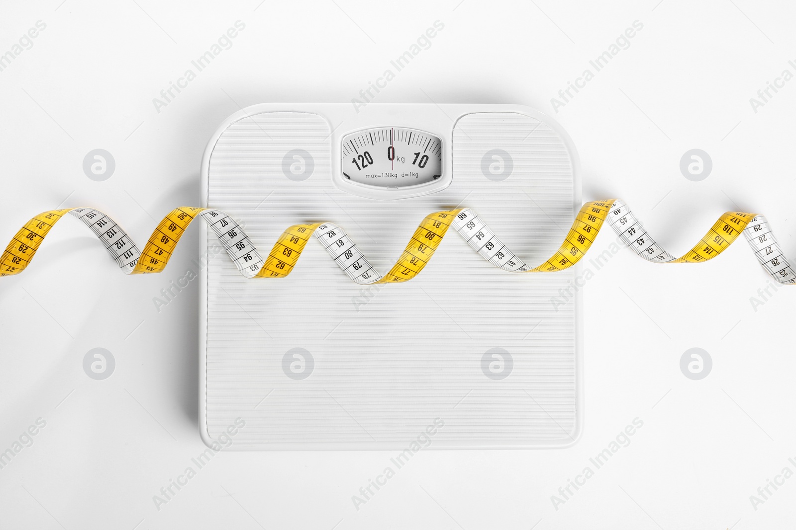 Photo of Measuring tape and scales on white background, top view. Concept of weight loss