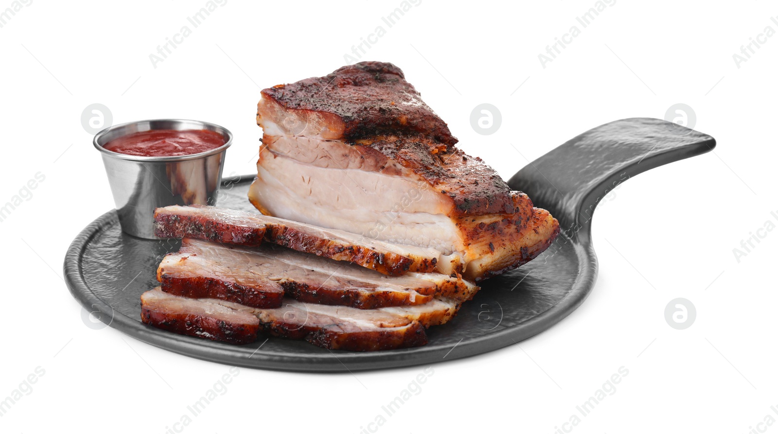 Photo of Pieces of tasty baked pork belly and sauce isolated on white