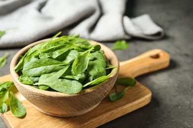 Fresh green healthy spinach on grey table. Space for text