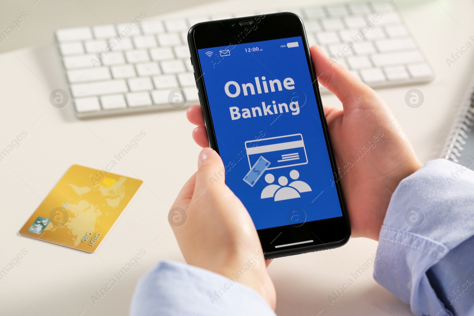 Photo of Woman using online banking app on smartphone at white office table, closeup