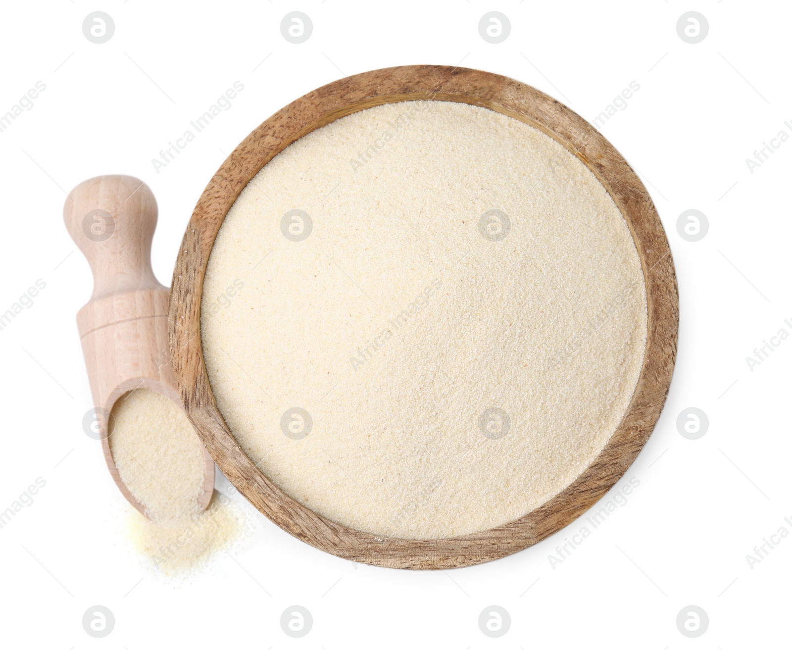 Photo of Uncooked organic semolina in wooden bowl and scoop isolated on white, top view