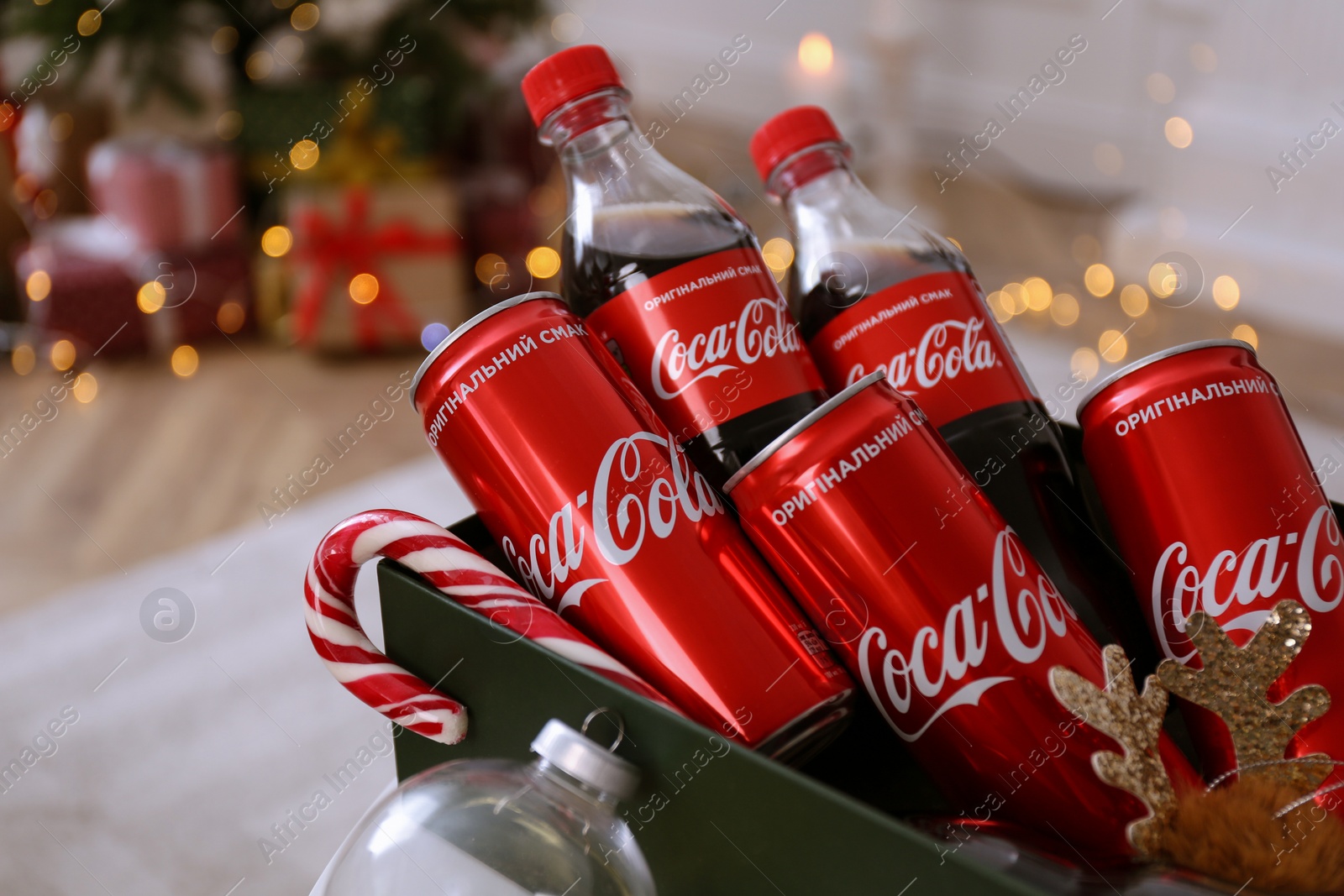 Photo of MYKOLAIV, UKRAINE - JANUARY 13, 2021: Coca-Cola bottles and cans in box, closeup