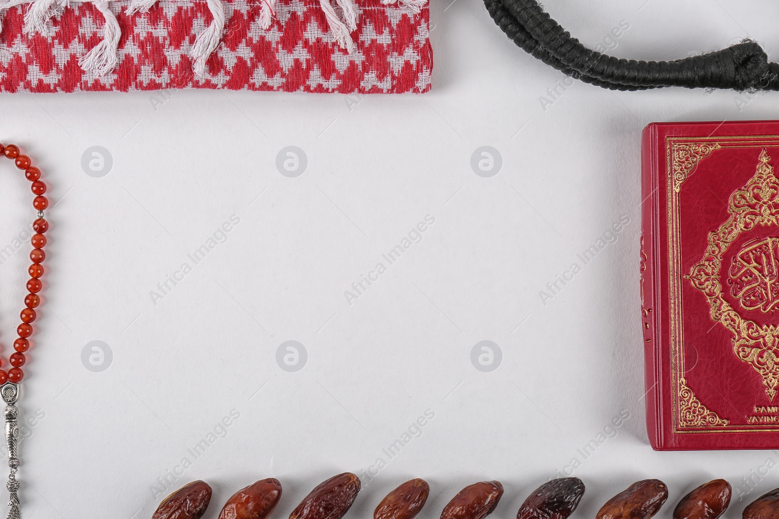 Photo of Flat lay composition with Muslim prayer beads, Quran and space for text on white background