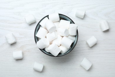 Photo of Delicious puffy marshmallows on white wooden table