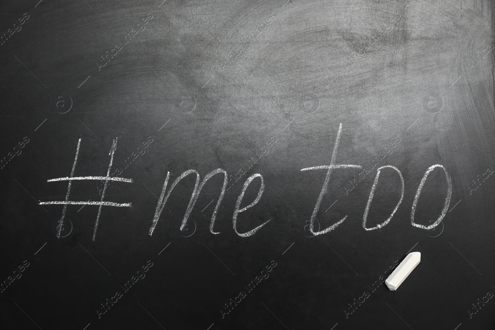 Photo of Phrase #METOO written on black chalkboard, top view. Space for text