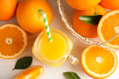 Flat lay composition with fresh orange juice on wooden background