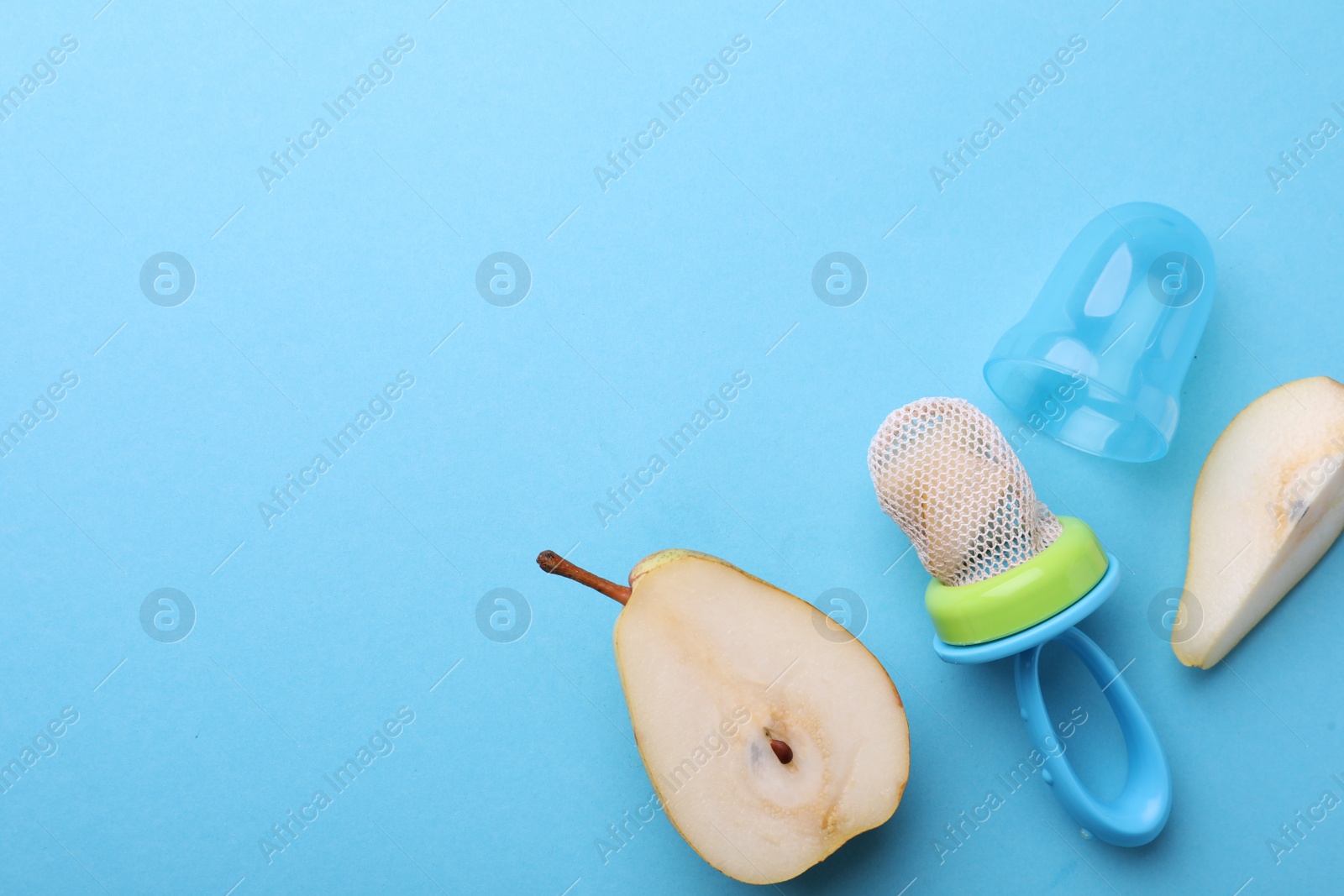Photo of Nibbler with fresh pear on light blue background, flat lay. Space for text