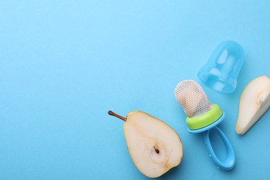 Photo of Nibbler with fresh pear on light blue background, flat lay. Space for text