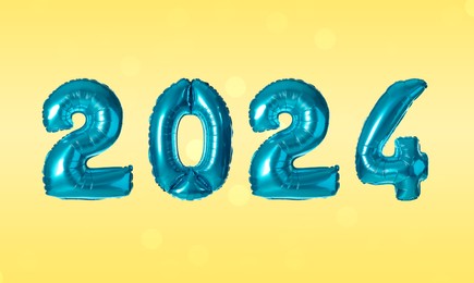 Image of New 2024 Year. Blue number shaped balloons on yellow background
