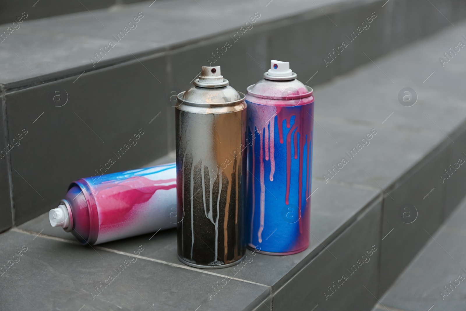 Photo of Used cans of spray paint on stairs