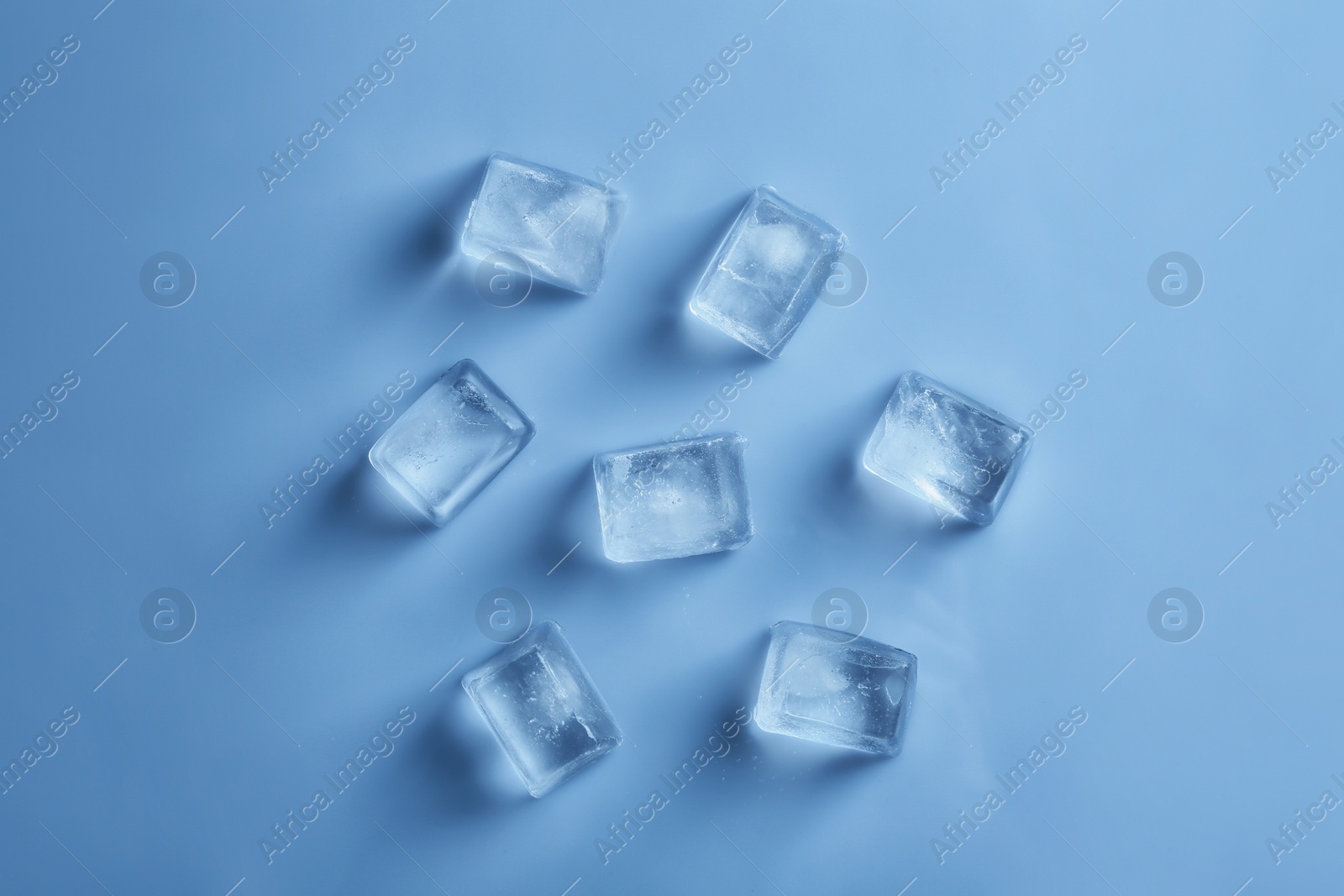 Photo of Ice cubes on color background, top view