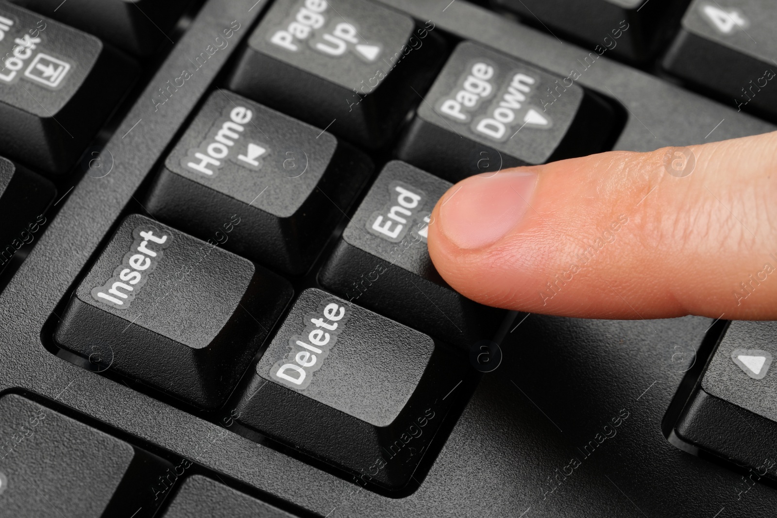 Photo of Man pressing button on computer keyboard, closeup