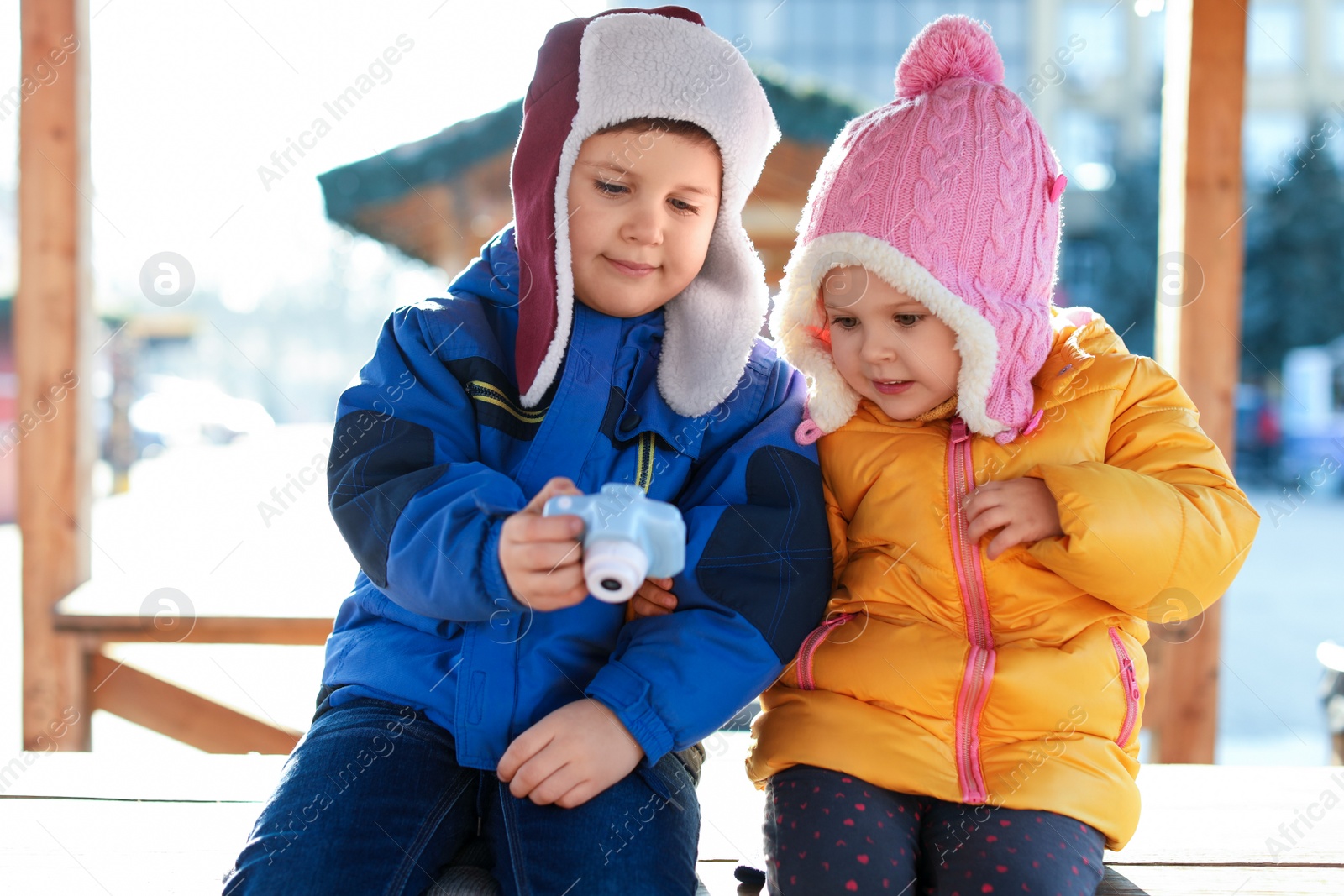 Photo of Cute children with toy camera outdoors. Future photographers