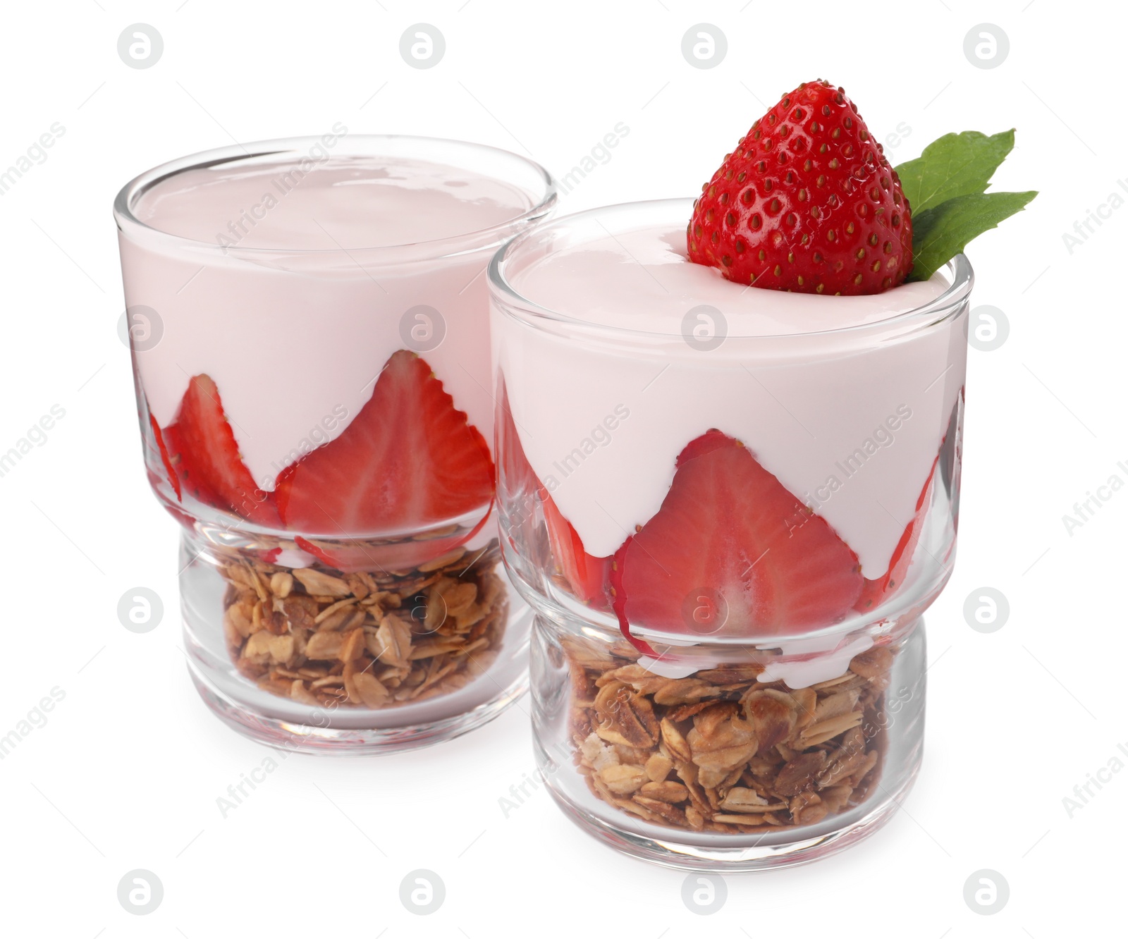 Photo of Glasses of tasty yogurt with muesli and strawberries isolated on white