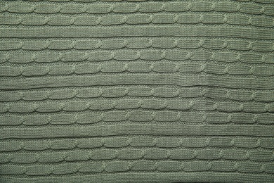 Photo of Soft knitted plaid as background, top view