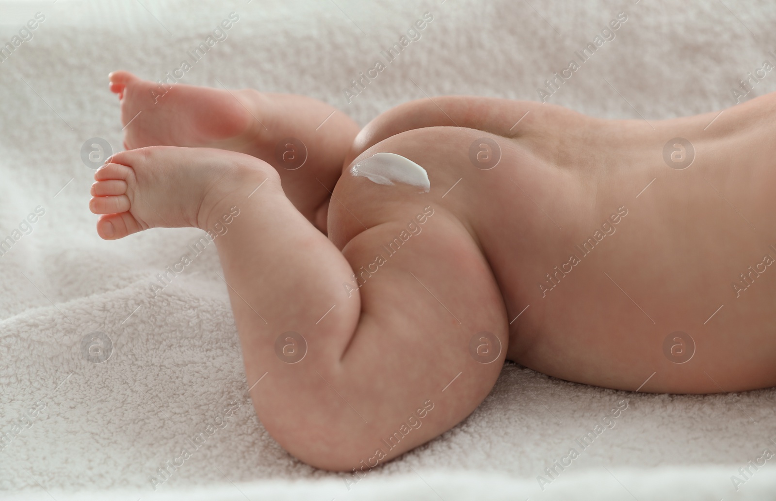 Photo of Cute little baby with cream on body, closeup