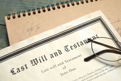 Photo of Last Will and Testament, notebook and glasses on rustic wooden table, closeup
