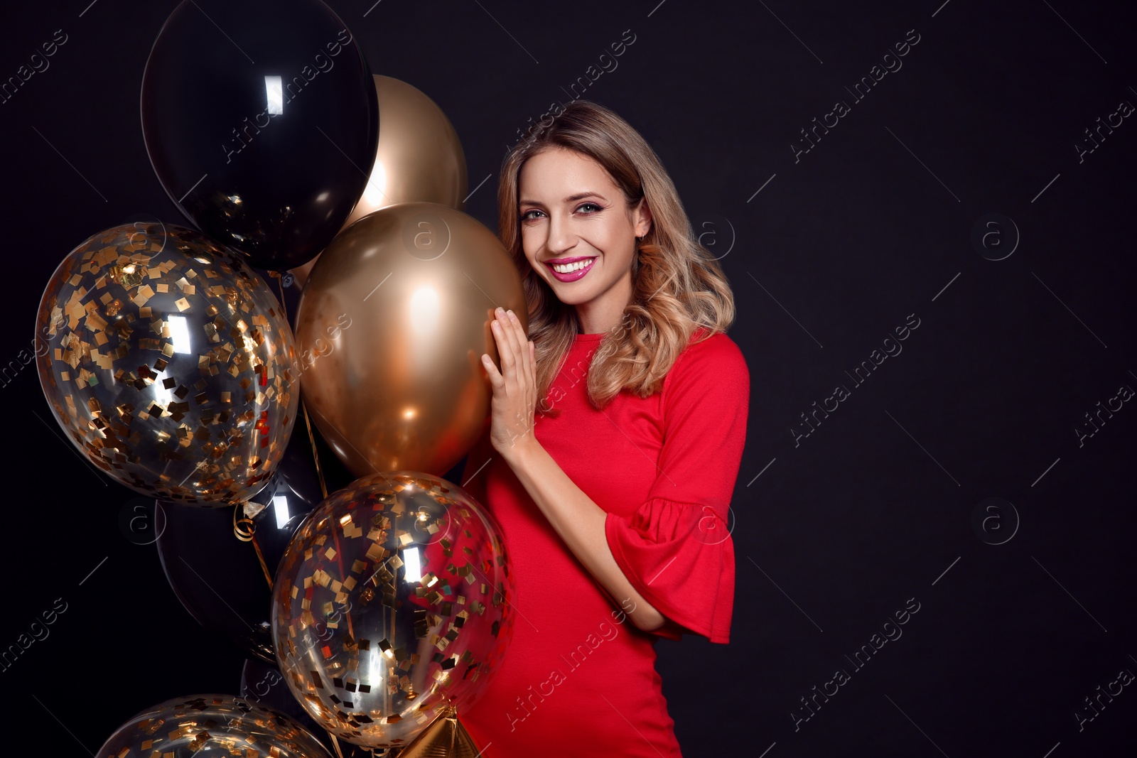 Photo of Happy woman with air balloons on black background, space for text. Christmas party