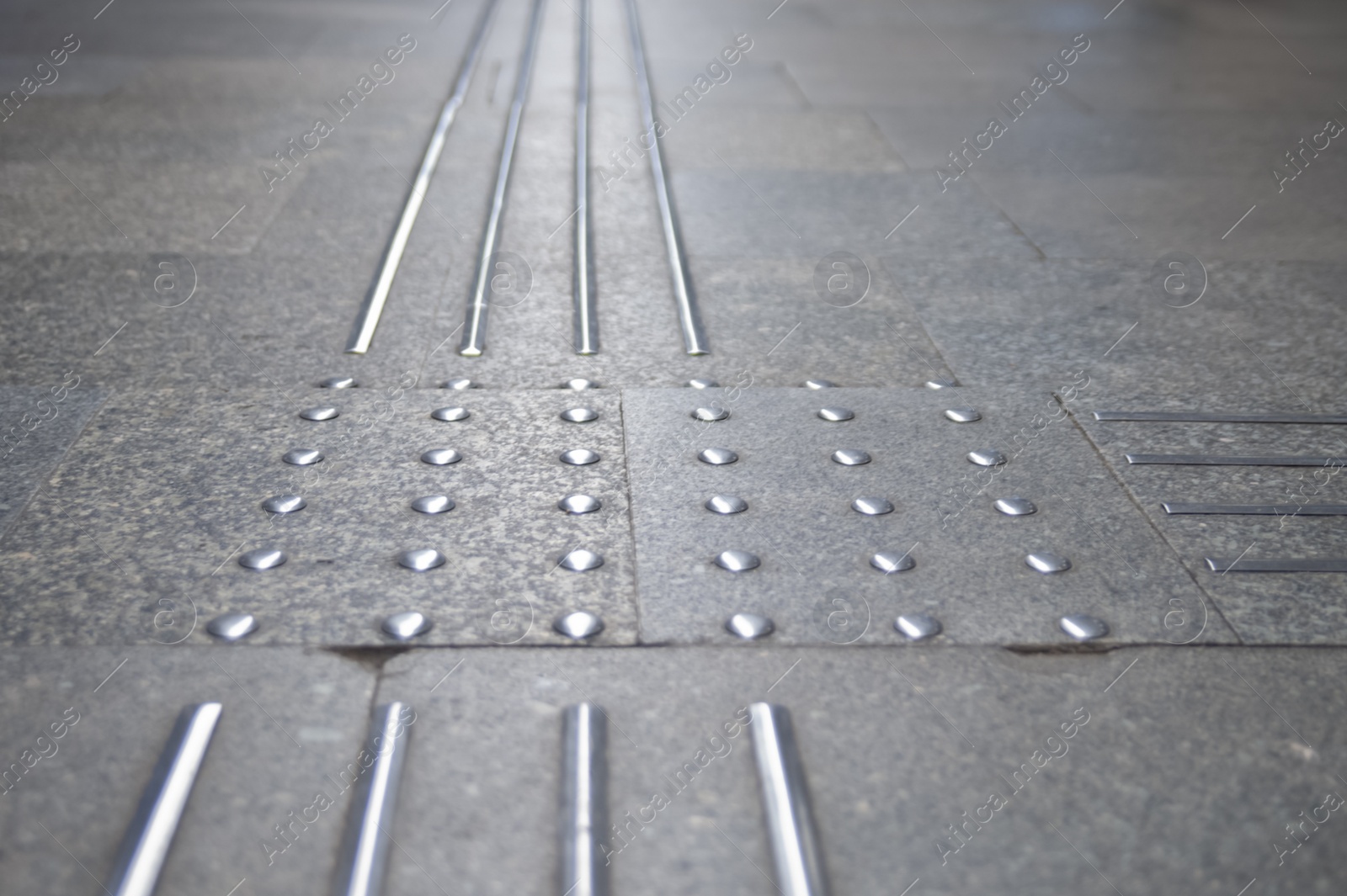 Photo of Floor tiles with tactile ground surface indicators, closeup view