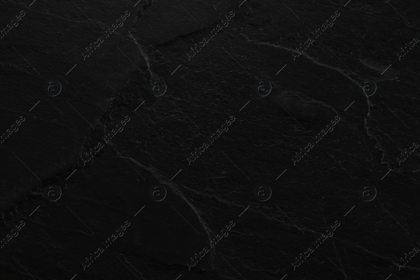 Photo of Texture of black stone surface as background, closeup