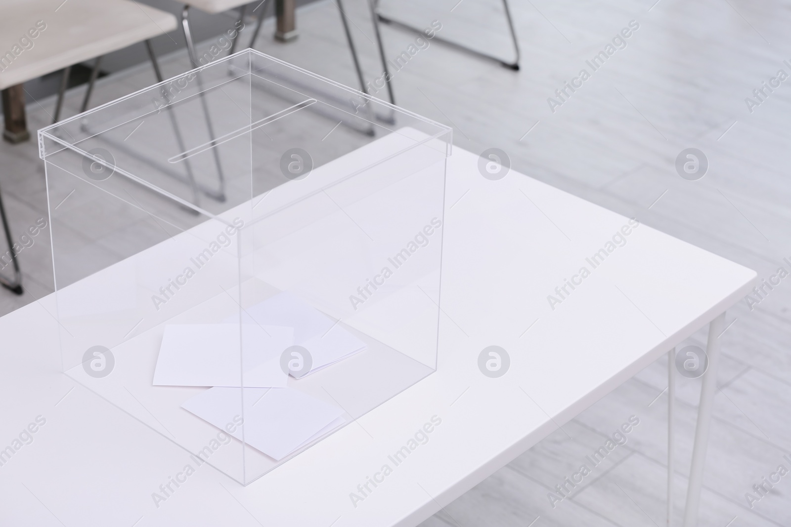 Photo of Ballot box on table at polling station. Space for text