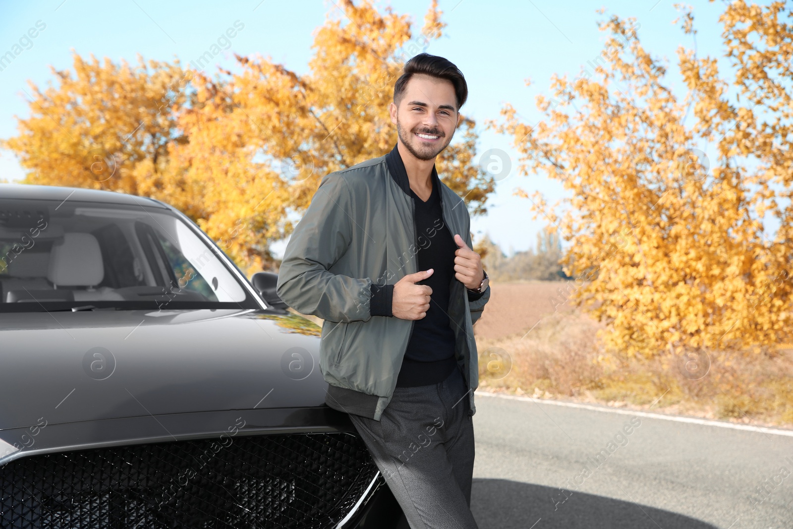 Photo of Young man near modern car on sunny day, outdoors