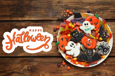 Image of Tasty cookies and sweets for Halloween party on wooden table, top view