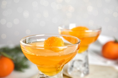 Photo of Delicious tangerine jelly in glass bowl, closeup