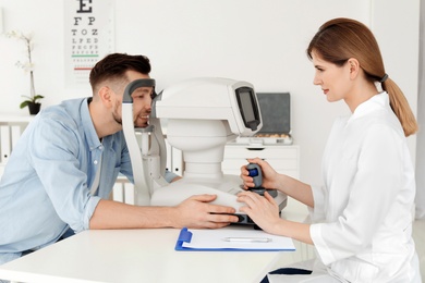 Ophthalmologist examining patient in clinic