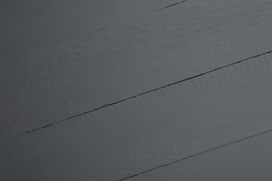 Texture of black wooden surface as background, closeup