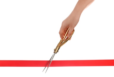 Photo of Woman cutting red ribbon with scissors on white background. Traditional ceremony