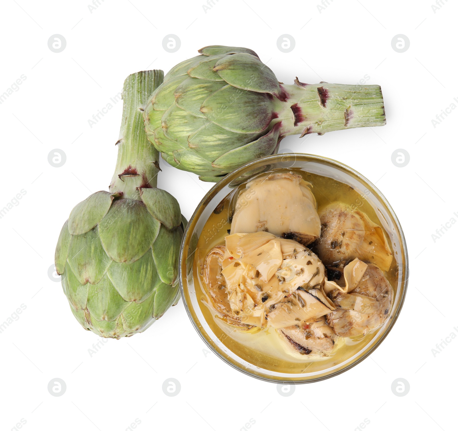 Photo of Bowl with delicious artichokes pickled in olive oil and fresh vegetables on white background, top view